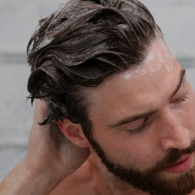 Man using ProLuxe Shampoo in the shower