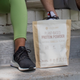 Woman sitting on some stairs with NeoraFit Plant-Based Protein Powder in front of her